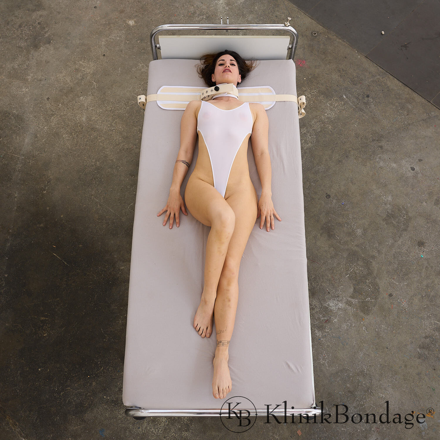 Helpless Brunette Strapped Tight in White