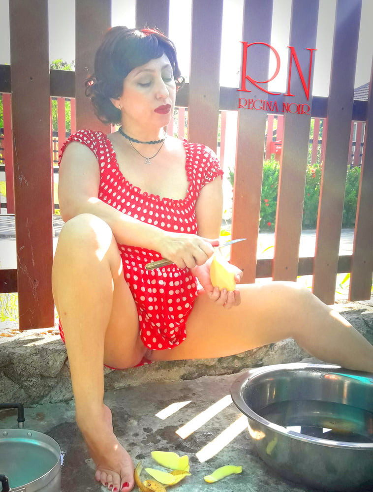 Retro maid prepares potatoes for dinner. Vintage performance